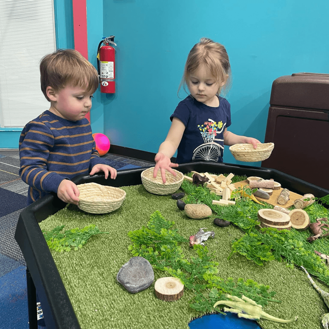 Children exploring the sensory table at Cowabunga’s