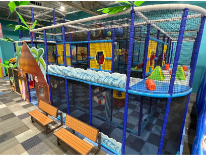 Children's three story play structure at indoor playground