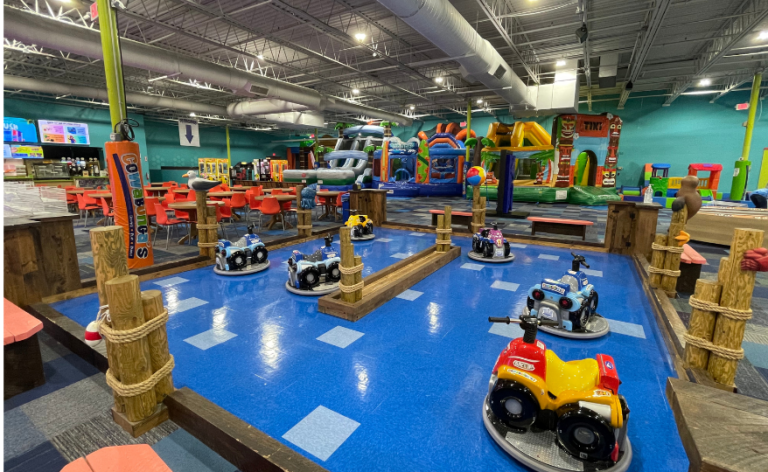 An expansive indoor play zone filled with various toys and a prominent slide, designed for children's entertainment and fun
