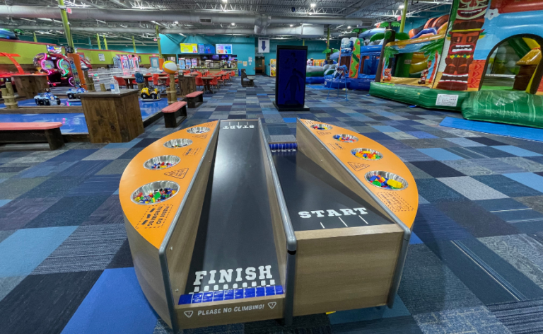 A spacious indoor play area filled with colorful toys and play structures for children to explore and enjoy