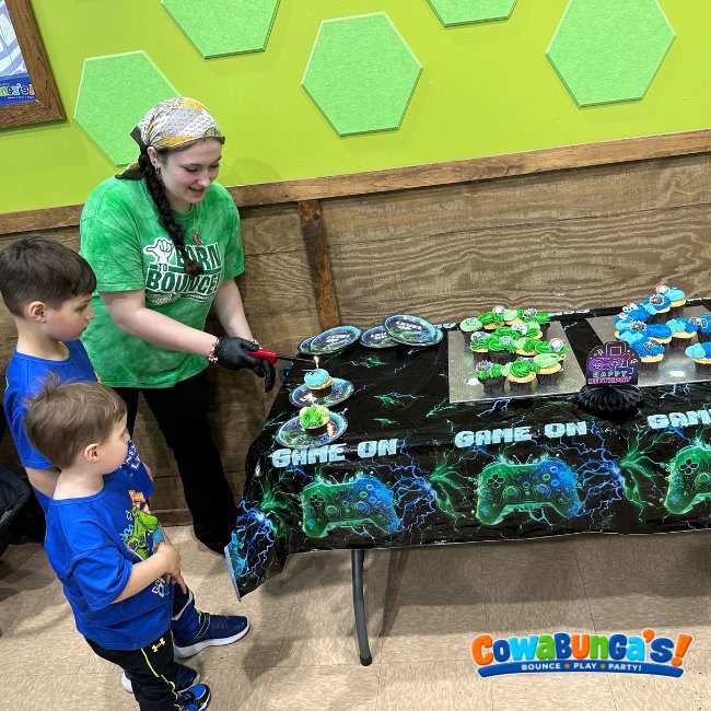 Birthday cake table with green decorations at Cowabunga’s Manchester, NH