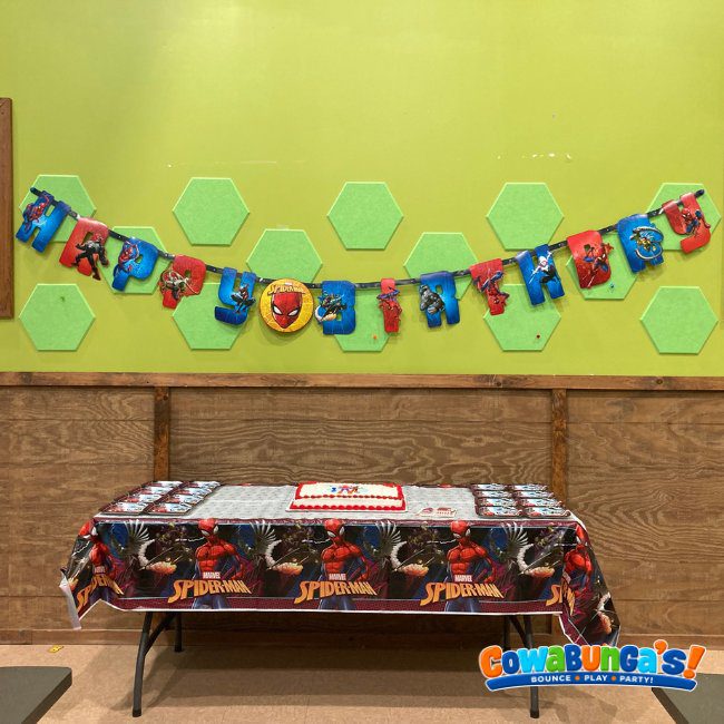 Birthday banner above a decorated party table at Cowabunga’s Manchester, NH