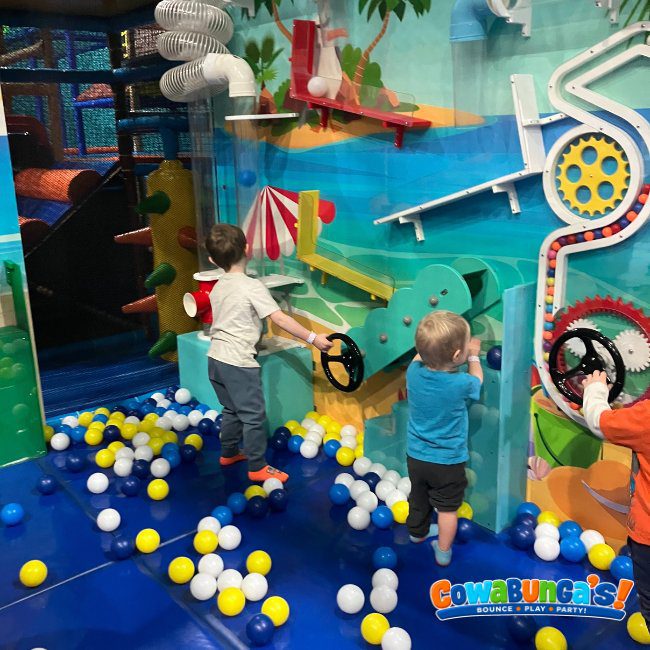 Children playing among colorful balls at Cowabunga’s Manchester, NH
