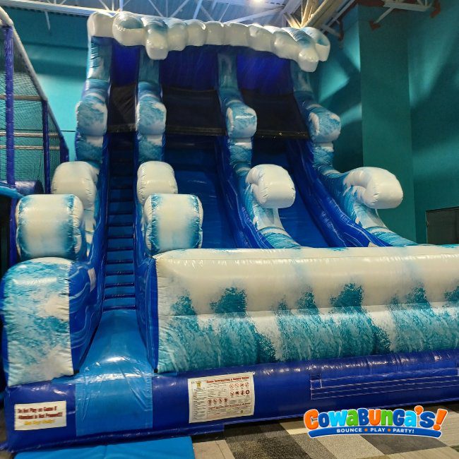 Large blue inflatable slide at Cowabunga’s Manchester, NH