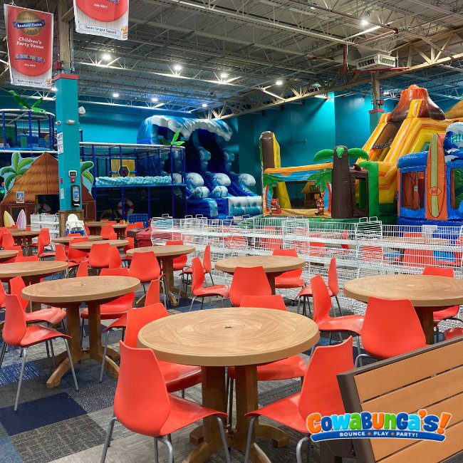 Wide view of seating and the indoor play area at Cowabunga’s Manchester, NH