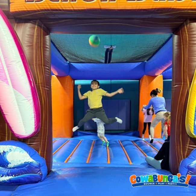 Children bouncing inside a colorful inflatable at Cowabunga’s North Reading, MA