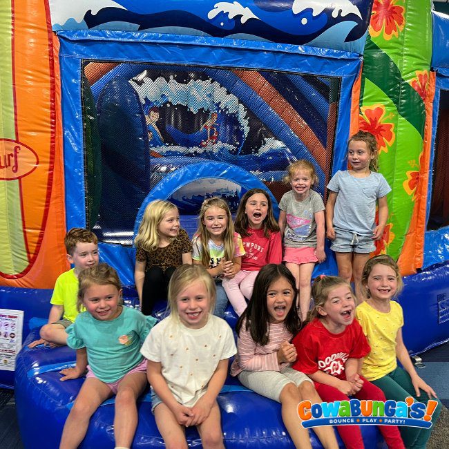 Birthday group posing by an inflatable at Cowabunga’s North Reading, MA