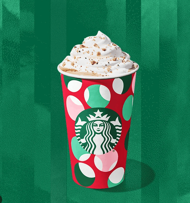 A warm Starbucks drink topped with whipped cream